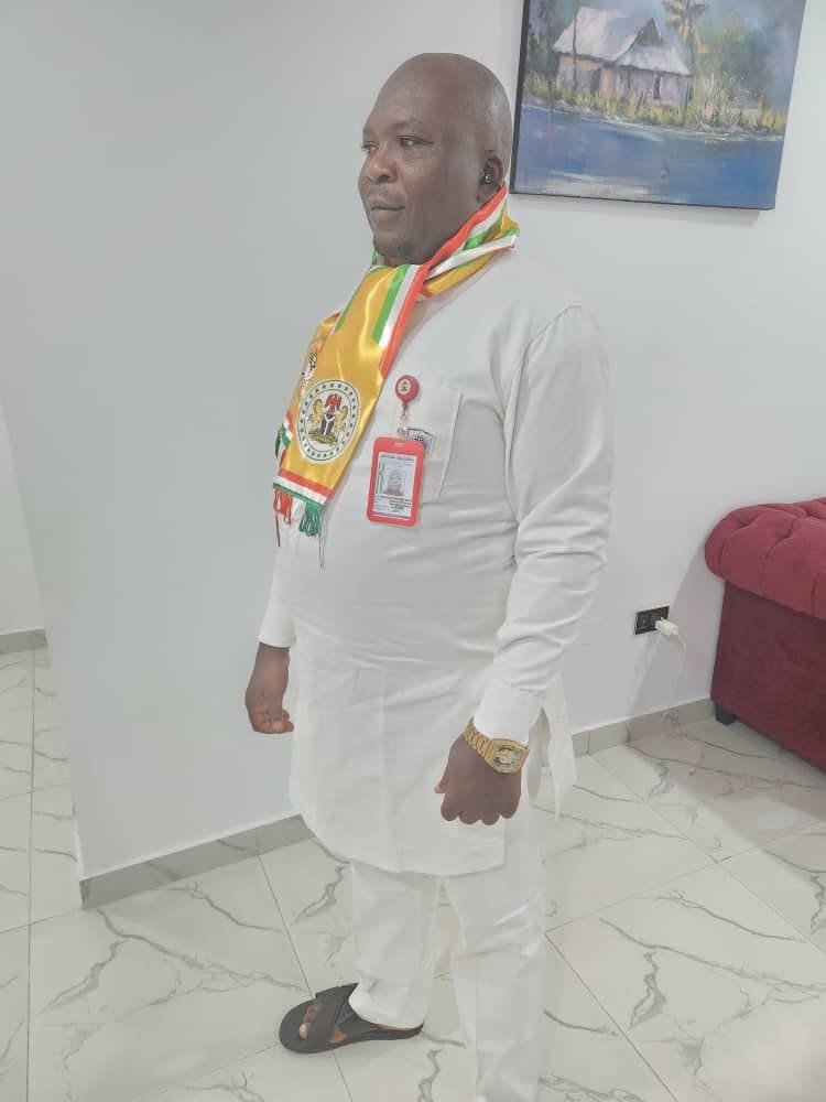Comr. Dr Atigwe Henry Ifeanyi in white attire with a Nigerian youth council sash
