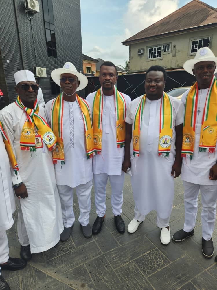 Five NYCN leaders in white attire and youth council sashes posing together outdoors