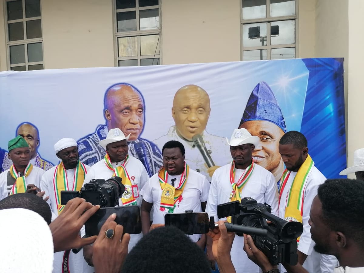 NYCN South East leaders addressing journalists with cameras and microphones in front of a banner